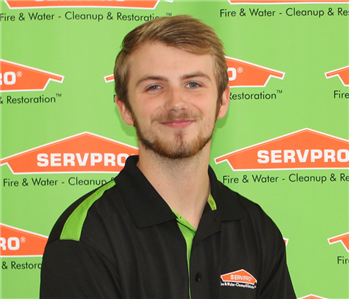 man in front of servpro banner