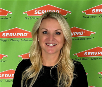 female in front of servpro backdrop