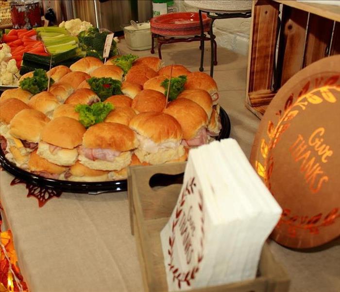 photo of sandwich tray, Thanksgiving napkins and plates on a decorated table
